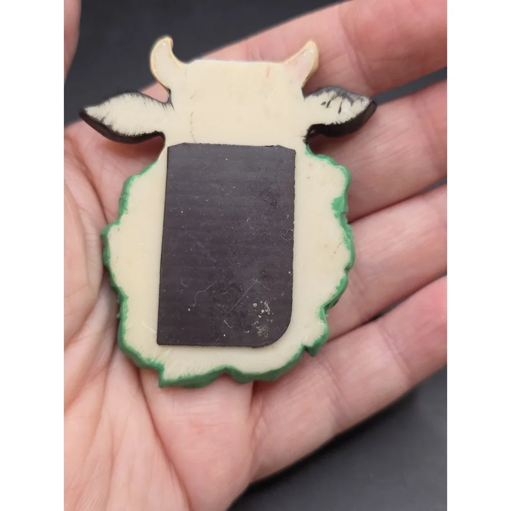 This collection features various vintage-style cow refrigerator magnets